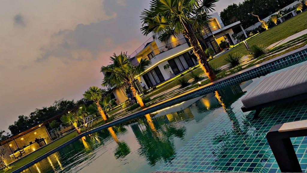 Pool lit up at night at Mellon Villa, Moinabad
